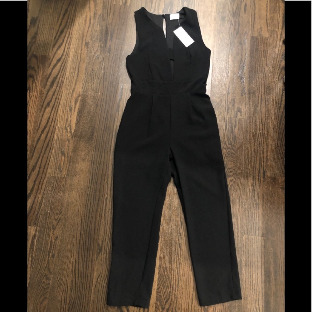 Black romper with plunge neck and cut out